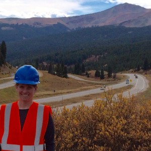 Paige Singer wearing a reflective vest and hard hat along the I-70 roadway